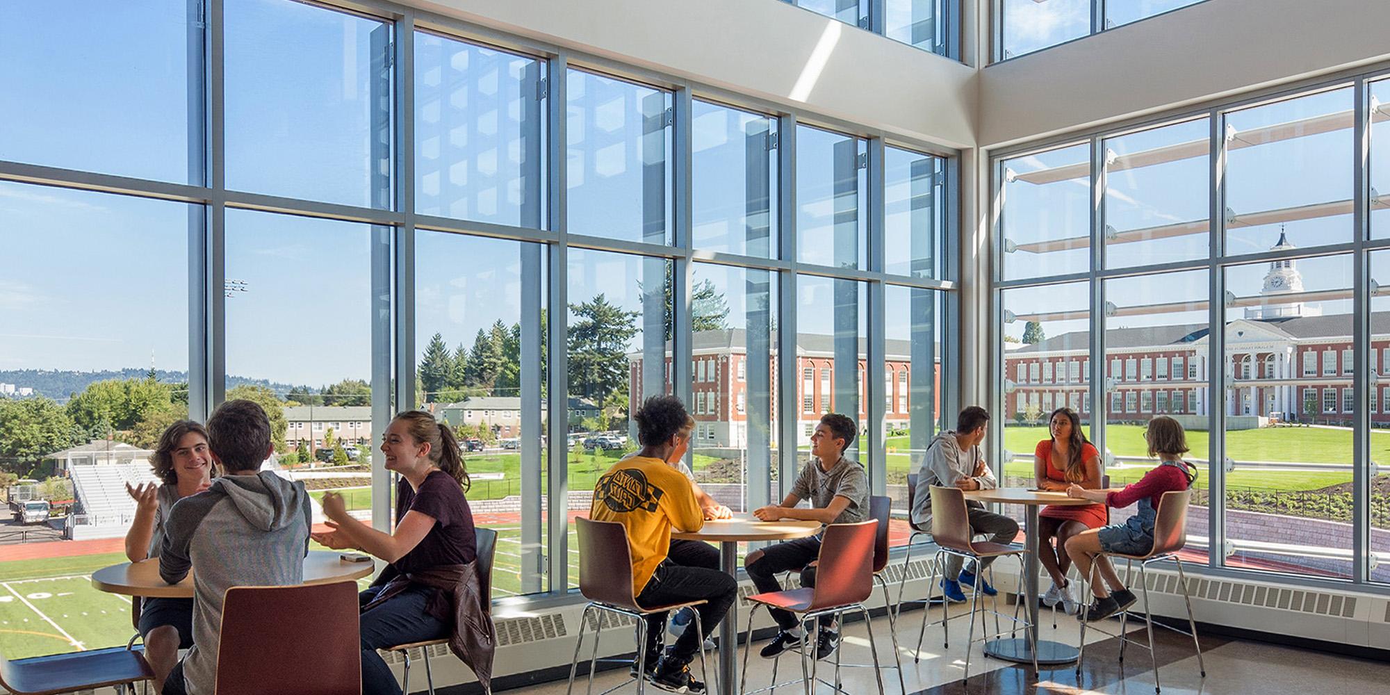 Students talking inside Franklin High School seating area